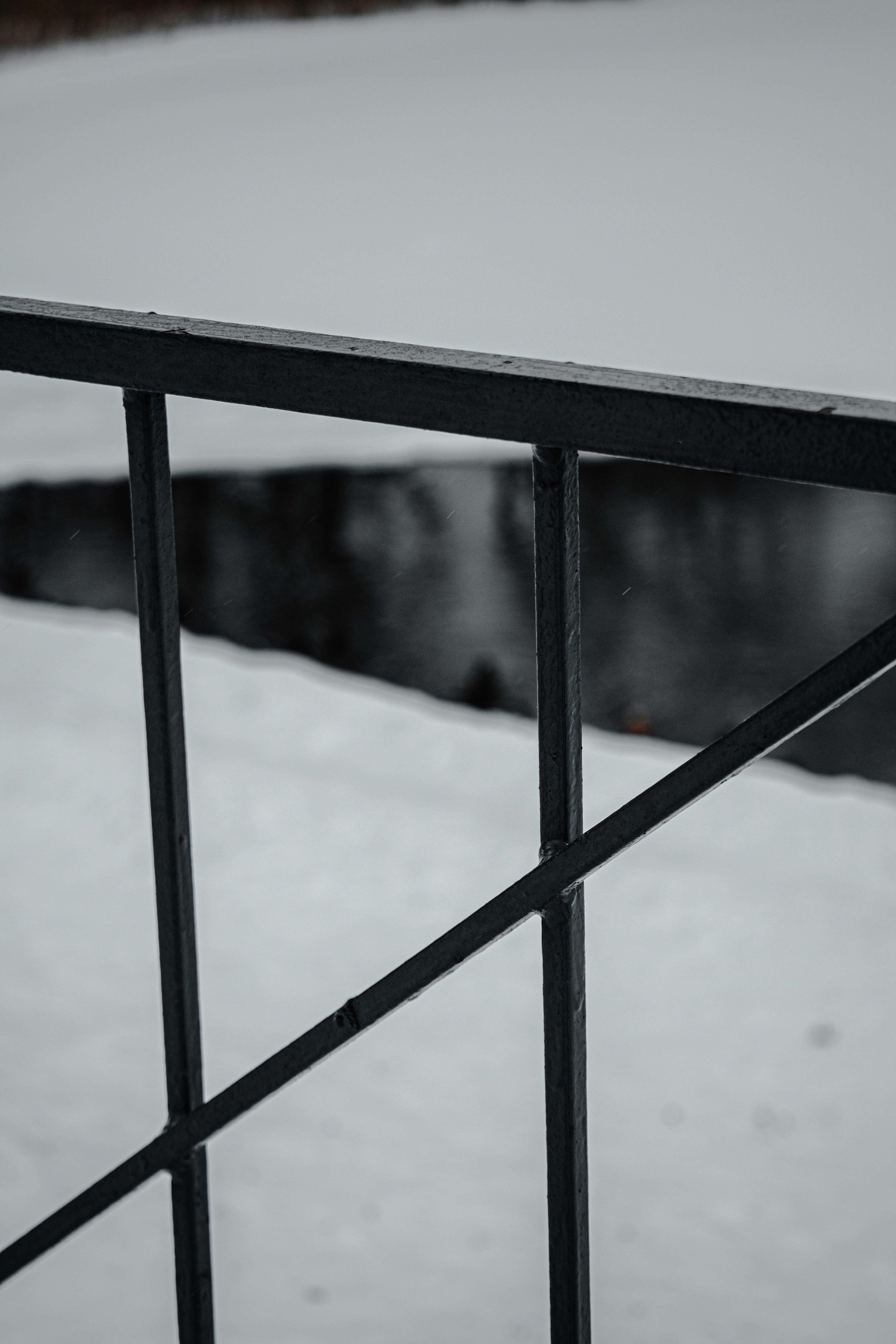 snow covered black metal fence